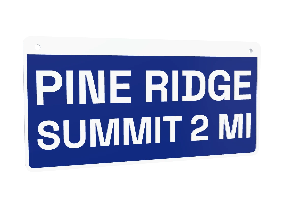 A 3D-printed trail sign reading PINE RIDGE, SUMMIT 2 MI: raised white letters in a deep blue epoxy fill, inside a white rounded plate with two screw holes